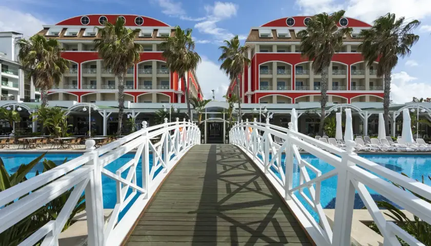 Mostek nad basenem prowadzi do hotelu w stylu Orange County w Belek.