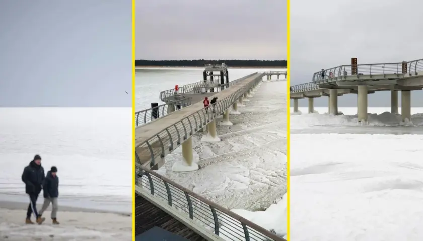 Spacerem po zamarzniętym Bałtyku, kiedy był skuty lodem. Widok na molo i plażę w zimowej scenerii.